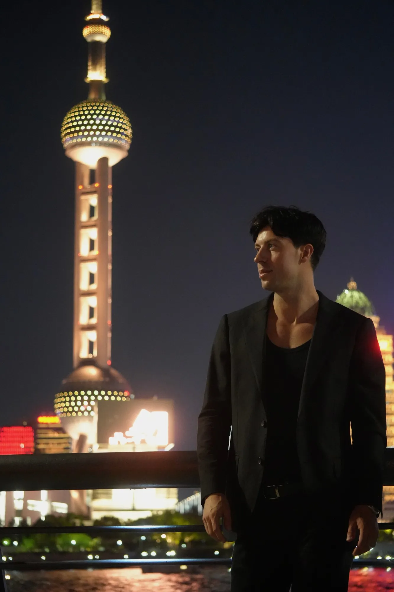 Olaf Groenewegen at night on the Bund in Shanghai, with the Oriental Pearl Tower behind him